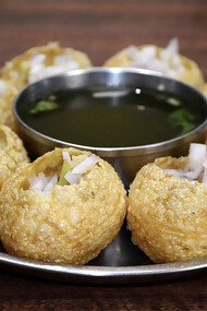 Panipuri—also known as golgappa, gappa, fuchka, phuchka, phuska, puska, batashe, padake, fulki, pakodi, or jalpooree—is a deep-fried, hollow, and crispy spherical shell, about 1 inch (25 mm) in diameter, traditionally filled with a mixture of potatoes, raw onions, chickpeas, and spices
