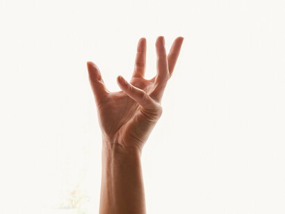 A hand reaching toward possibility, suspended between fear and hope
