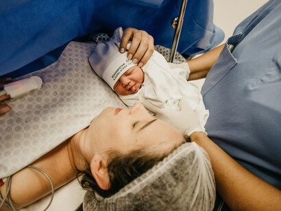 A mother is lovingly reunited with her baby immediately after birth