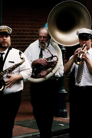 A vibrant crowd listening to musicians perform at a street festival in New Orleans, USA