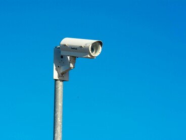 CCTV camera against the blue sky, representing facial recognition technology
