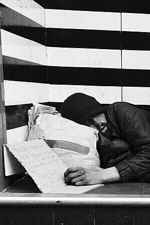 "Homeless Man Sleeping on a Step,"  photograph, Allan Warren, 2015