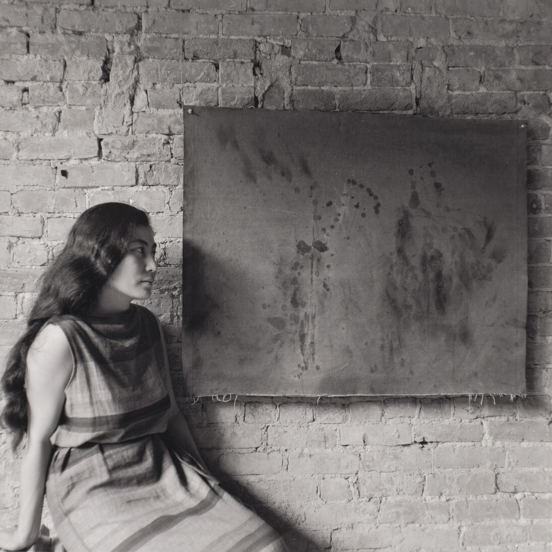 Painting to See in the Dark (Version 1). 1961. Installation view with the artist, Paintings & Drawings by Yoko Ono, AG Gallery, New York, July 17–30, 1961. Photograph by George Maciunas. The Museum of Modern Art, New York. The Gilbert and Lila Silverman Fluxus Collection Gift, 2008. © 2014 George Maciunas