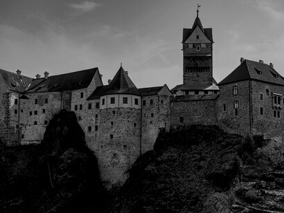 A majestic Gothic castle perched on a rocky cliff in the Czech Republic