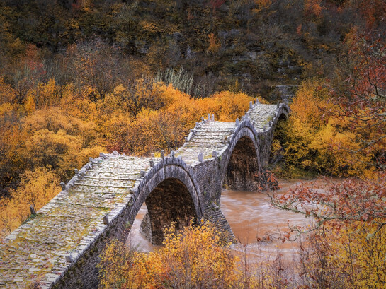 Plakidas Bridge, located near the villages of Kipi and Koukouli in Central Zagori, Greece, is one of the region’s most distinctive stone bridges