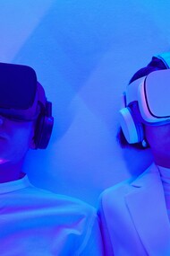 Two people wearing virtual reality headsets 