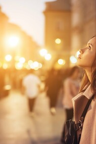 A woman travelling alone in a distant city, mirroring the solitary moments in the journey that shaped clarity and inner strength