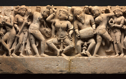 Frieze with Dancer and Musicians, a dancer, who strikes a pose in the center, is accompanied by a full orchestra of musicians in lively variegated poses. At the far left, a woman plays the cymbals, her mouth open in song, Northwestern India, Rajasthan, Sikar, Harshagiri, 10th century