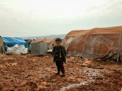 Little boy in a Syrian refugee camp—symbols of resilience amid crisis and uncertainty