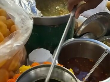 Traditional gol gappa preparation by a vendor on the lively streets of Mumbai, India