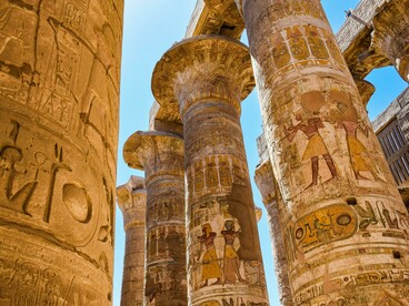 Detailed hieroglyphs carved on the massive columns of Karnak Temple in Luxor, Egypt