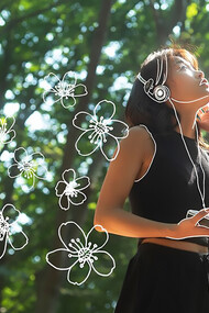 A woman posing outdoors, surrounded by nature, embodying the principles of personal growth and the Japanese philosophy of Oubaitori