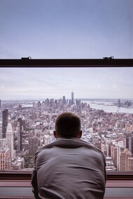 A person sat looking out of a building. Self-talk can be as varied and complex as our own personalities