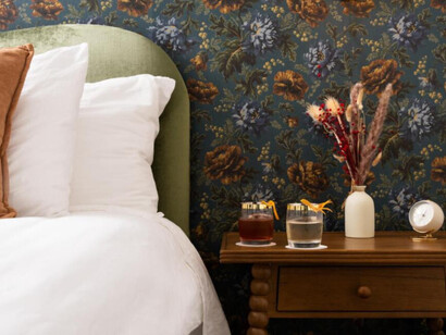 A cozy, stylish bedroom corner with a rich, vintage-inspired feel