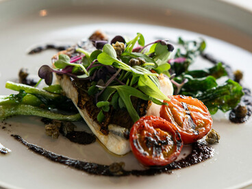 A beautifully plated gourmet fish and vegetable dish inspired by the Paleo diet, photographed in Tokyo, Japan