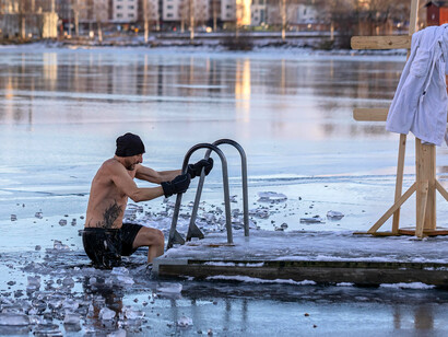 Man in a frozen lake, harnessing the power of cold plunge ice baths to boost vitality and longevity