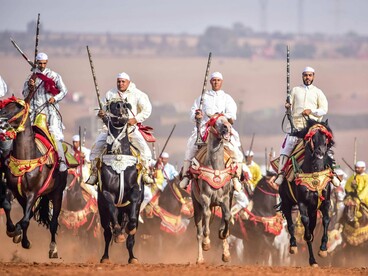 Traditional Moroccan Fantasia horsemen riding in unison, symbolizing collective intention and strategic coherence