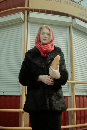 Woman in black fur coat with bread, Soviet Russia