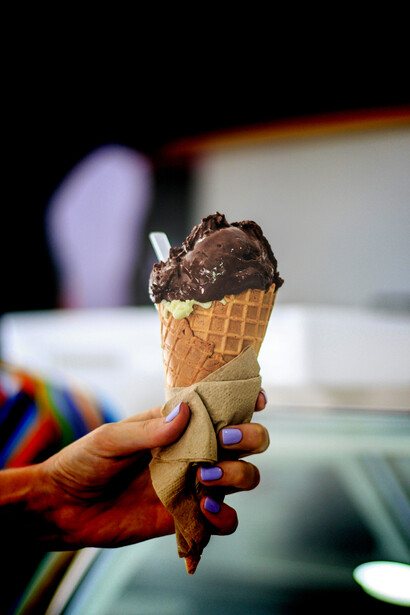 Close-up shot of hands holding multiple ice cream cones