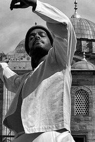 A dervish by a mosque 