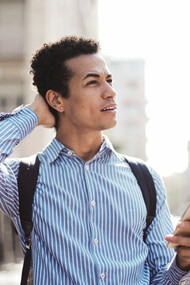 As smartphones redefine brain training, a man captivated by his device exemplifies the modern approach to sharpening cognitive skills