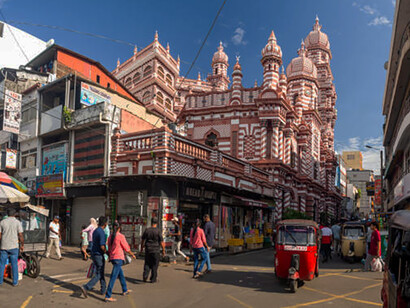 The lively streets of Colombo showcase bustling crowds and a vibrant mix of shops and businesses, Sri Lanka
