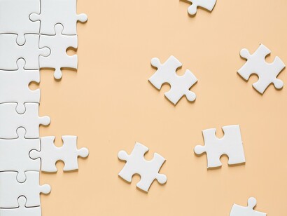 A scattered puzzle with missing pieces, symbolizing the challenges of resolving conflict and finding common ground