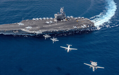 South China Sea  (Oct. 9, 2019), Aircraft from Carrier Air Wing (CVW) 5 fly in formation over the forward-deployed aircraft carrier USS Ronald Reagan (CVN 76), flagship of Carrier Strike Group 5
