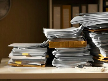Pile of official documents representing administrative bureaucracy