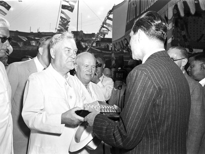 Soviet leaders Nikolai Bulganin and Nikita Khrushchev receive souvenirs during their visit to a jute mill in Calcutta in November 1955, as part of an official state visit to India