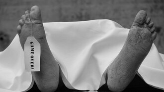 Black-and-white image of feet resting on white fabric, symbolizing a body prepared for burial on marble