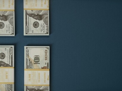 An abstract wall of currency hints at the system’s expectations 