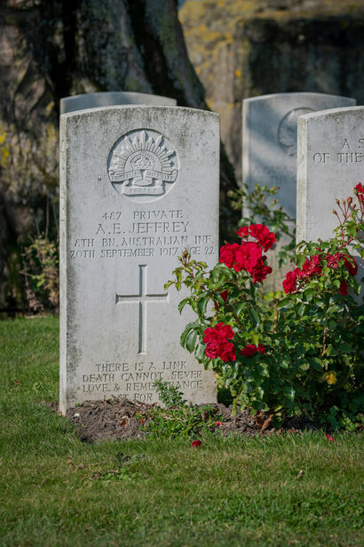 United Kingdom – A World War I military cemetery gravestone adorned with roses