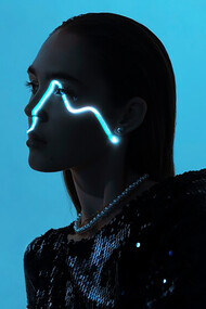 Portrait of a young woman against a vibrant blue backdrop