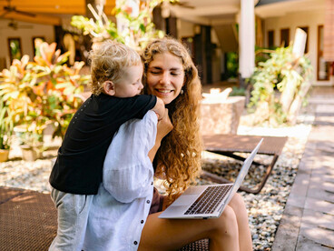A working mother staying present with her child, illustrating the dual roles women manage without recognition