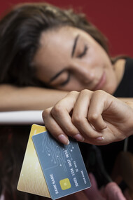 A woman after shopping, holding credit cards 