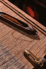 An industrial sewing machine using tweed as its fabric
