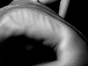 Grayscale images of nude bodies often reveal the vulnerability behind body image issues, reflecting how social media imposes unrealistic beauty standards