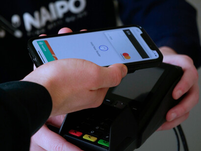 A person making payment using their phone, showing the simplicity of using mobile money for transactions