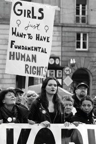 Women march together, proudly holding a banner that reads: "Girls Just Want to Have Fundamental Human Rights