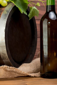 Wooden barrel oak with bottle and glass of wine