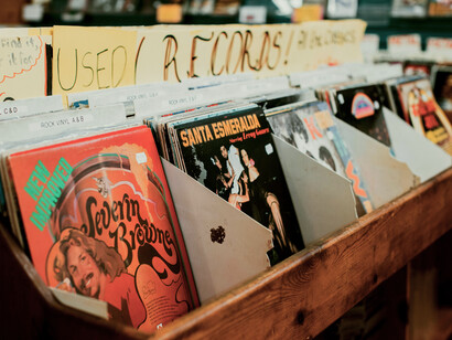 A small independent record label workspace inside a vintage vinyl record store