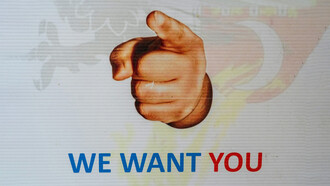 A sign reading 'We Want You,' inviting individuals to join a recruitment process or apply for a job