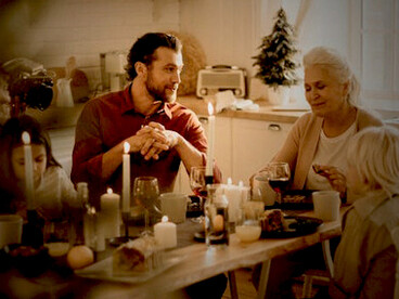 The family gathers around the table, celebrating Christmas with a delicious holiday meal