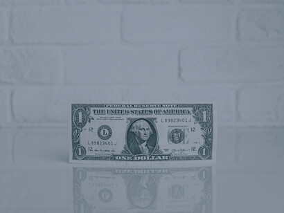 A single note of currency placed on a table demonstrates how funding is necessary and continues to be the largest barrier for women in the technology industry