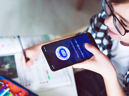 A smiling boy interacting with an AI-powered chatbot, highlighting the role of AI in virtual assistance