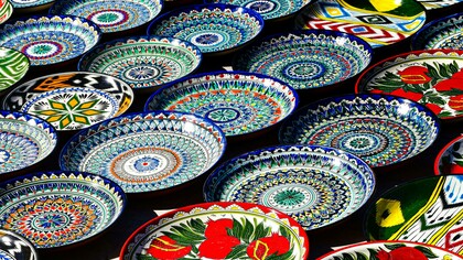 Colorful traditional mosaic plates crafted by local artisans in Bukhara, Uzbekistan