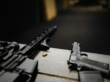 A close-up of firearms, reflecting the normalisation of force in global diplomacy