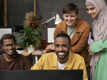 A diverse team collaborating on a project, symbolizing the spirit of partnership at the heart of Fulbright programs between Morocco and the United States