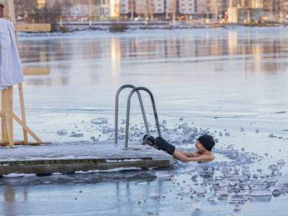 Immersed in icy waters, a man takes the cold plunge — a practice linked to resilience, renewal, and longevity
